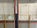 a set of three glass display cases with gold trimming