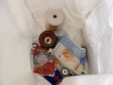 a white bag filled with toilet paper and other items