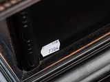 a sticker on the door handle of a black dresser
