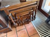 a stack of three wooden tables sitting on a tiled floor