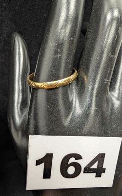 un gros plan d'une bague en or à la main d'un mannequin