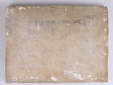 an old book sitting on top of a table next to a white wall
