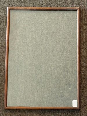 a framed picture of a painting on a carpeted floor