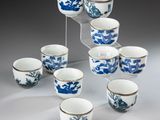 six blue and white cups and saucers are arranged in a pyramid