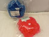 two balls of yarn wrapped in plastic bags on a bed