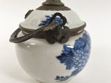 a small blue and white vase with a bird on it