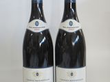 two bottles of wine sitting next to each other on a table