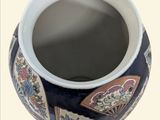 a blue and white vase with a design on it