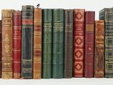 a lot of books that are stacked on top of each other