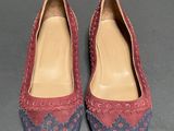 pair of women ' s shoes with red and blue sued uppers