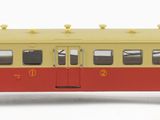 a yellow and red train car on a white background