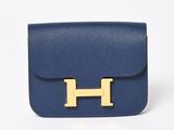 a blue leather handbag with a gold h logo on the front