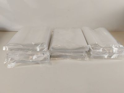 three rolls of white tissue sitting on top of a table