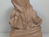 statue of a woman holding a baby in her arms on a white surface