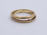 a close up of a gold ring on a white surface