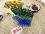a plate with a peacock on it sitting on a table