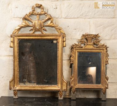 two mirrors sitting on a table next to a brick wall