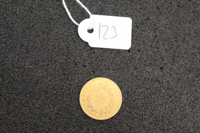a small gold coin with a price tag on it