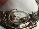 a person that is holding a watch in their hand