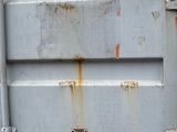 a close up of a metal door with rust on it