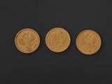 three different types of gold coins on a black background