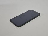 the back of an iphone with a black case sitting on a white surface