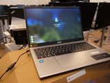 a laptop computer sitting on top of a cardboard box