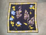 purple and blue flowers on a black square scarf with yellow border