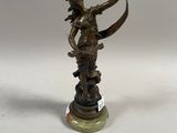 bronze figurine of a woman with a bow on a marble base