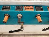 a blue machine that has a bunch of buttons on it