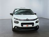 the front of a white citrole parked in a white room
