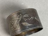 a close up of a silver ring with a bird on it