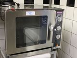 a silver microwave sitting on top of a counter in a kitchen