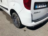 a small white van parked on the side of the road
