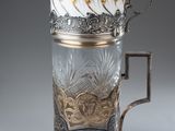 a glass cup that has a handle on it