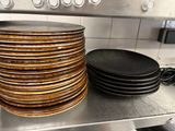 a stack of plates sitting on top of a stove