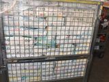 a cart full of newspapers sitting in a warehouse