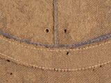 an image of a close up of a brown hat with holes in it
