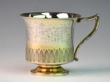 a silver cup that is sitting on a table