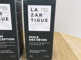 two boxes of lazarr figue cosmetics sitting on a wooden table