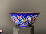 a blue bowl sitting on top of a wooden stand