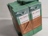 two boxes of tea are stacked on top of each other on a table