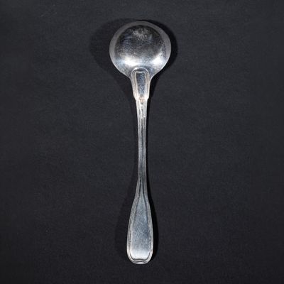 a spoon that is sitting on a black surface