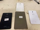 several different cell phones are lined up on a table
