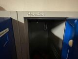 a blue metal locker with a door open in a room