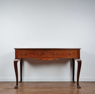 a small wooden table sitting on top of a hard wood floor
