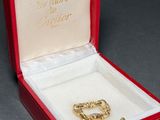 a red box with a gold ring inside of it