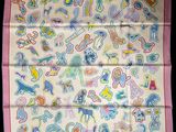 a close up of a pink scarf with a bunch of cartoon characters on it