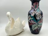 two vases sitting next to each other on a white surface