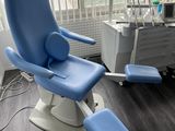 a blue chair that is in a room with a window